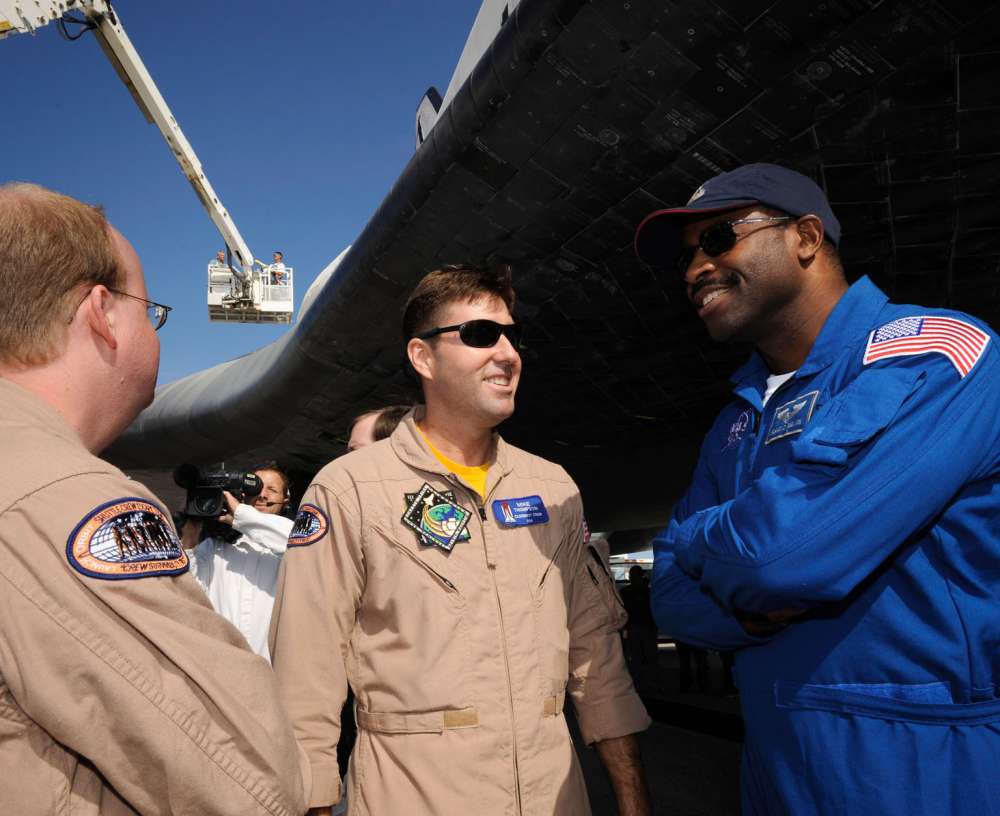 Leland Melvin (right), STS-122 mission specialist, talks with Daniel Palmer (left) and Mike Thompson (members of the space shuttle close-out crew): 72 KB